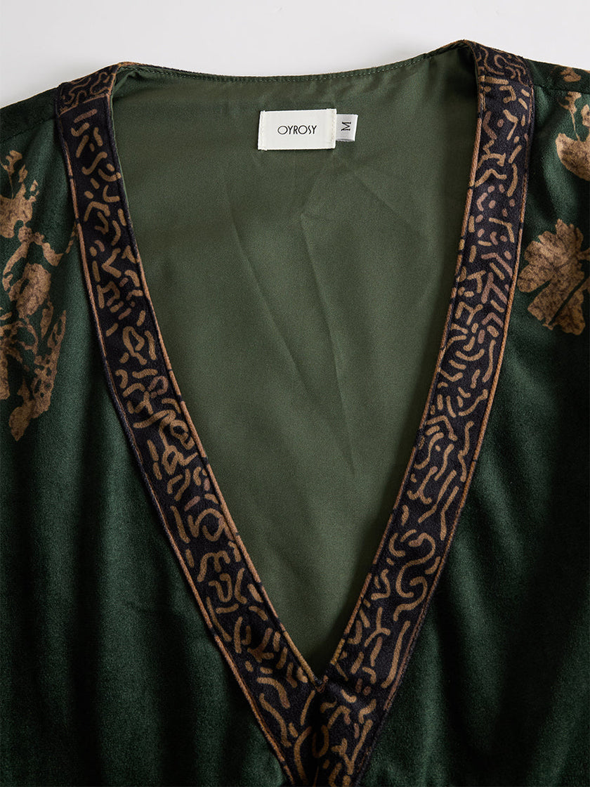 Green faux suede tassel maxi dress for women by FJØRNA, featuring a flowing silhouette and stylish tassel details.