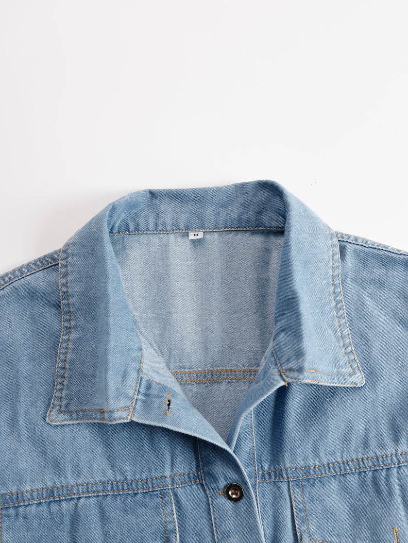 FJØRNA denim tassel mini dress showcasing casual style with fringed details and a fitted silhouette.