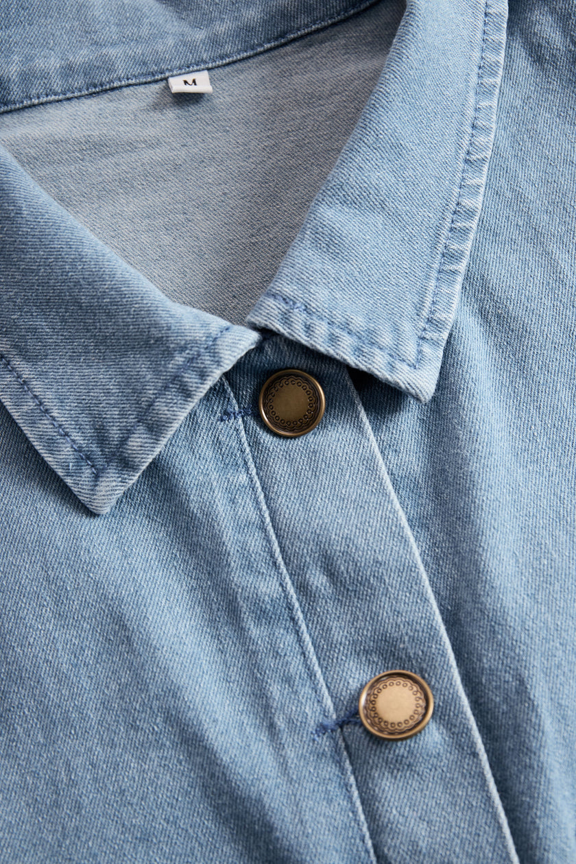 Light blue denim flared long sleeve wide-leg jumpsuit for women by FJØRNA, featuring a stylish and comfortable fit.