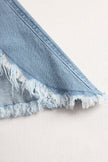 Light blue denim flared long sleeve jumpsuit for women by FJØRNA, featuring wide-leg pants and a stylish, casual fit.