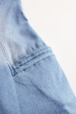 Light blue denim sleeveless jumpsuit with raw edges and wide-leg pants for women, styled by FJØRNA.