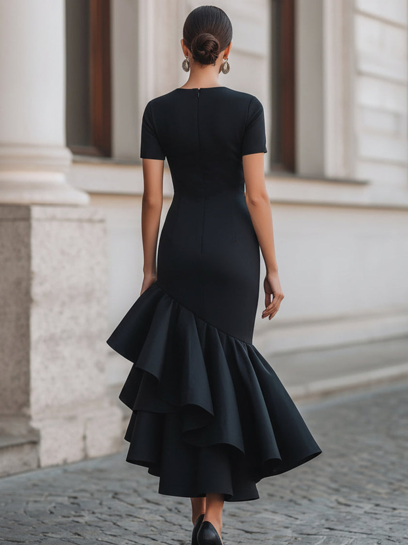 Black FJØRNA asymmetric ruffle-hem midi dress featuring a stylish ruffle detail and elegant silhouette.