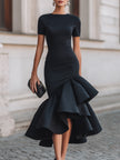 FJØRNA black asymmetric ruffle-hem midi dress featuring a stylish ruffle hem and elegant fit, perfect for chic occasions.