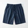 Men's summer linen shorts by FJØRNA, light and breathable fabric, shown in a relaxed fit with casual style.