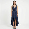 Women's elegant sleeveless wrap midi dress by FJØRNA, showcasing a stylish design with a fitted waist and flowing fabric.