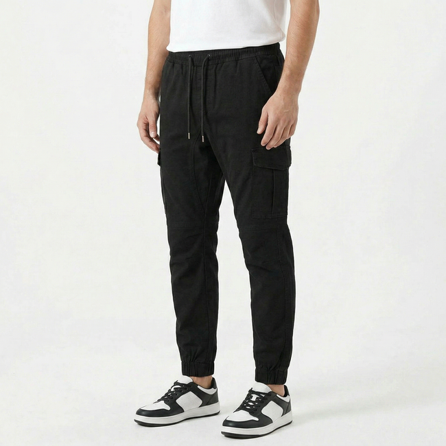 Men's slim fit cotton cargo trousers by FJØRNA, showing the front view with multiple pockets and a sleek, modern design.