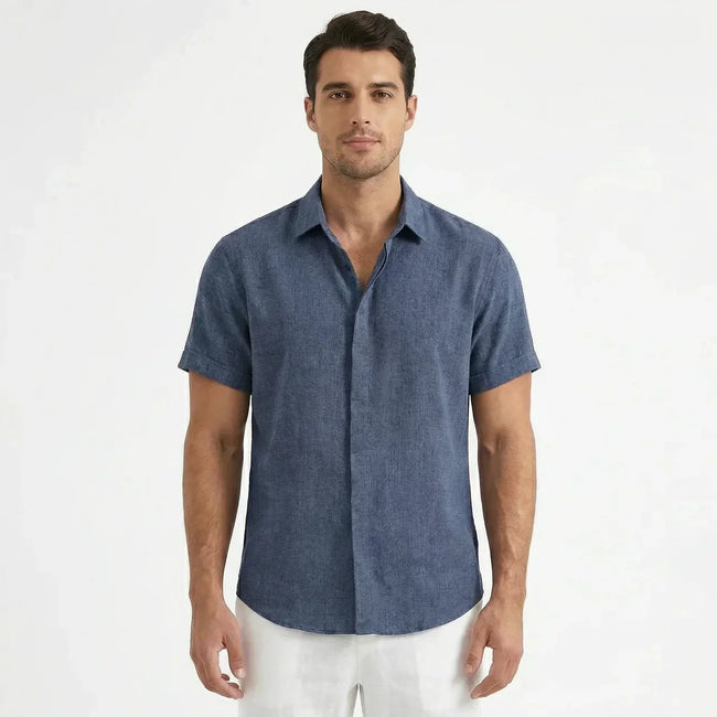Men's FJØRNA cotton-linen short sleeve shirt displayed on a hanger, featuring a lightweight, breathable fabric and classic collar.