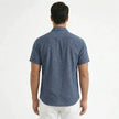 Men's FJØRNA cotton-linen short sleeve shirt, light fabric with a casual fit and button-up front, displayed on a hanger.