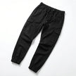 Men's slim fit cotton cargo trousers by FJØRNA, showing the front view with multiple cargo pockets and a tapered leg fit.