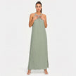 FJØRNA women's sleeveless halter neck summer maxi dress with flowing fabric and vibrant floral pattern.