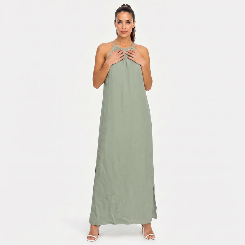 FJØRNA women's sleeveless halter neck summer maxi dress with flowing fabric and vibrant floral pattern.