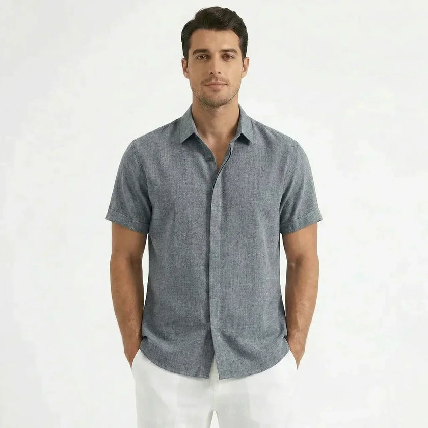 Men's FJØRNA cotton-linen short sleeve shirt displayed on a hanger, featuring a casual design with a button-up front and collar.