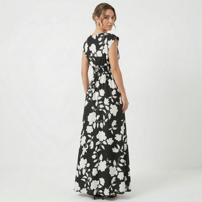 Women's floral print V-neck summer maxi dress by FJØRNA, flowing fabric with vibrant floral pattern and sleeveless design.