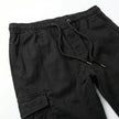 Men's slim fit cotton cargo trousers by FJØRNA, showcasing the relaxed fit, multiple cargo pockets, and classic khaki color.