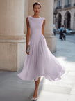FJØRNA sleeveless pleated midi dress with draped neckline, perfect as a wedding guest dress, shown in elegant fabric and design.