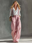 Pink cotton linen wide-leg women's dungarees by FJØRNA, styled as casual pants with adjustable straps and relaxed fit.
