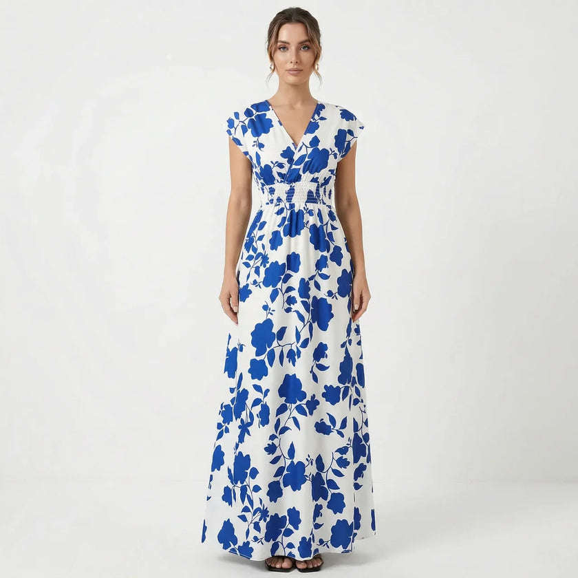 Women's V-neck floral print summer maxi dress by FJØRNA featuring a flowing design and vibrant floral pattern.