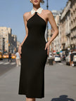Black halter midi dress by FJØRNA featuring a white Peter Pan collar, ideal for cocktail events and stylish occasions.