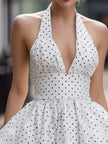 FJØRNA vintage white halter polka dot bubble mini dress for women, featuring a fitted bodice and playful polka dot pattern.