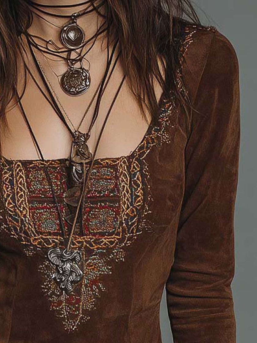 Brown suede embroidered boho mini dress by FJØRNA featuring a leather dress look with intricate embroidery and a flowy silhouette.