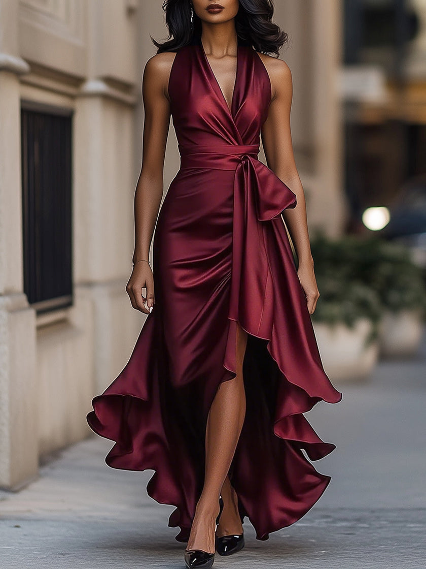 FJØRNA navy satin halter ruffle gown, elegant black tie dress with flowy ruffle details and sleek satin finish.