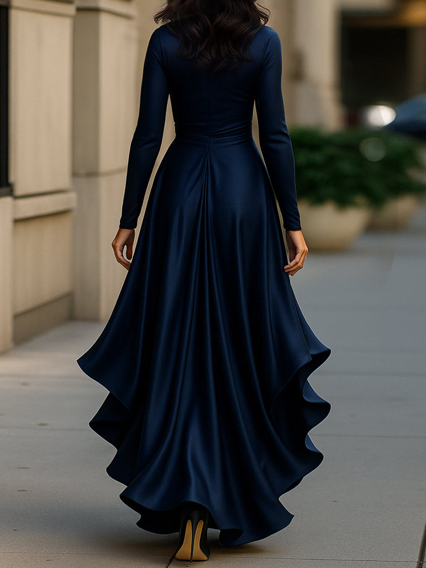 Navy blue satin maxi dress by FJØRNA featuring draped fabric and ruffle details, elegant and flowing design.