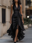 Navy satin halter ruffle gown by FJØRNA featuring elegant design and flowing fabric, perfect for black-tie events.