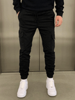 Men's black cargo jogger trousers by FJØRNA featuring a relaxed fit, multiple pockets, and tapered ankle design.
