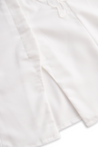 White sleeveless floral embroidery blouse for women by FJØRNA, featuring intricate floral details and a sleeveless design.