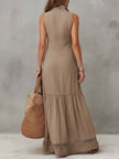 FJØRNA khaki cotton sleeveless maxi dress for women displayed on a hanger, showcasing its flowy fabric and sleeveless design.