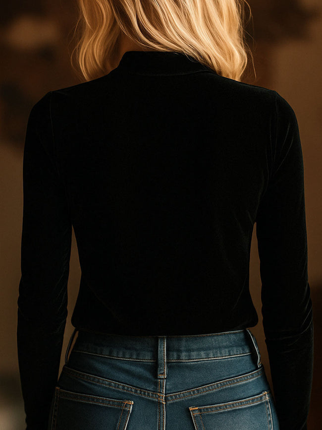 Black FJØRNA velvet V-neck long sleeve top with embroidered design, featuring a stylish and comfortable T-shirt silhouette.