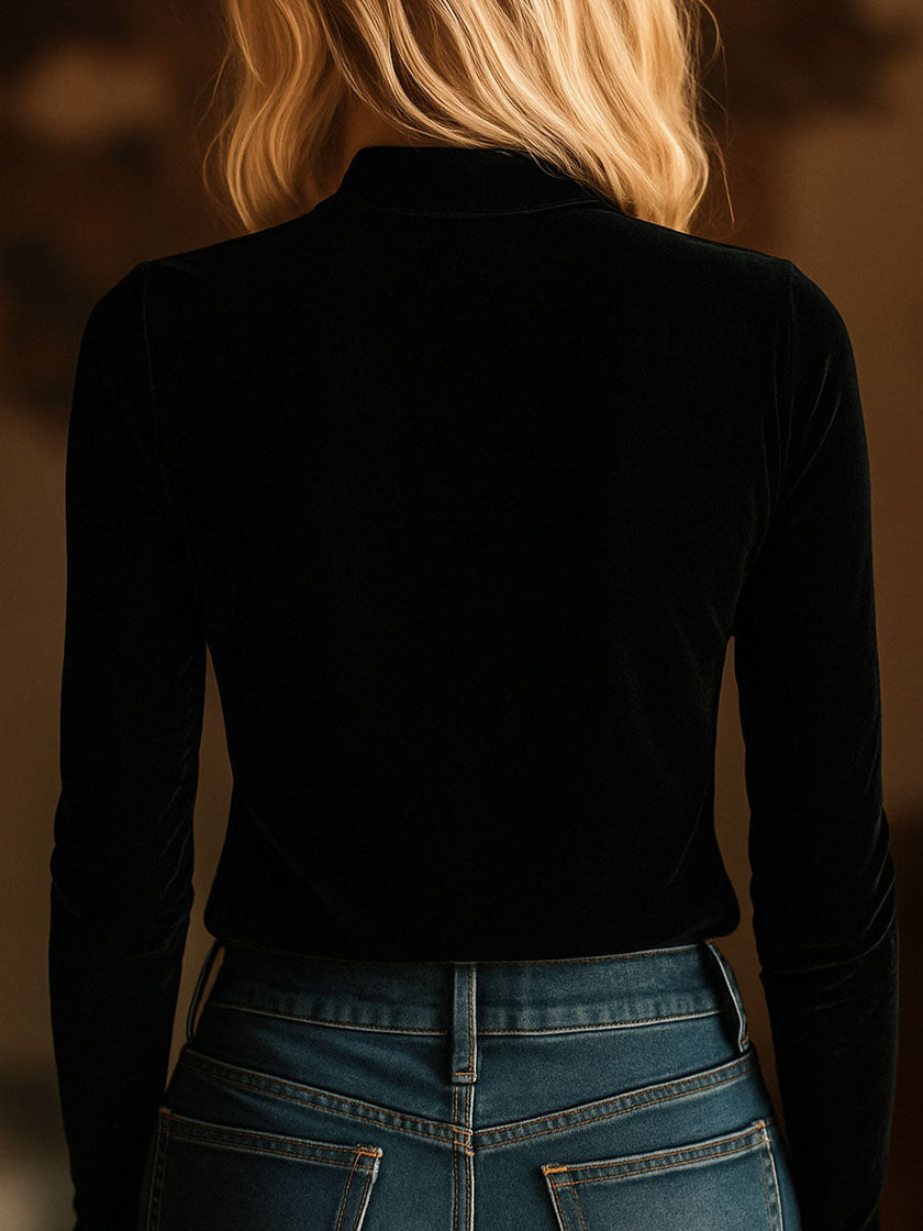 Black FJØRNA velvet V-neck long sleeve top with embroidered design, featuring a stylish and comfortable T-shirt silhouette.