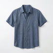 Men's FJØRNA cotton-linen short sleeve shirt with a relaxed fit, featuring a button-up front and classic collar on a plain background.