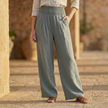 White high waist wide leg trousers for women by FJØRNA, showing the flowing, relaxed fit and smooth fabric.