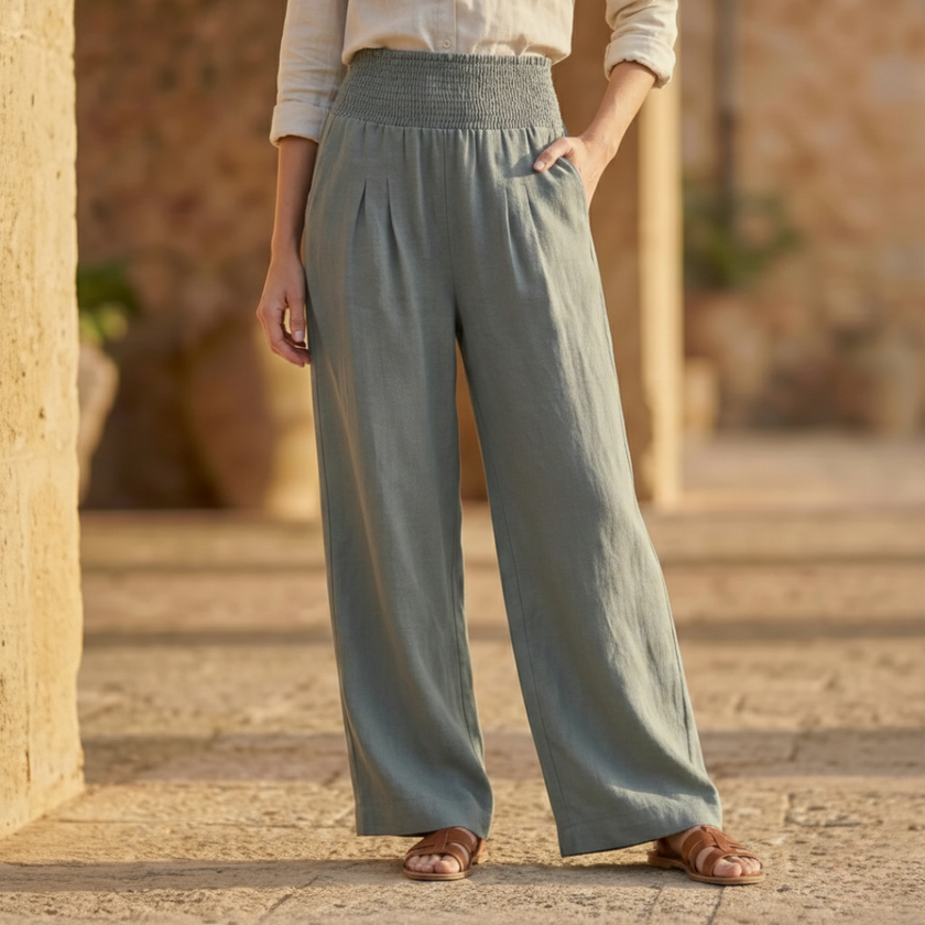 White high waist wide leg trousers for women by FJØRNA, showing the flowing, relaxed fit and smooth fabric.
