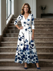 FJØRNA women's floral summer maxi dress with V-neck wrap design displayed on a model, lightweight and flowy fabric.