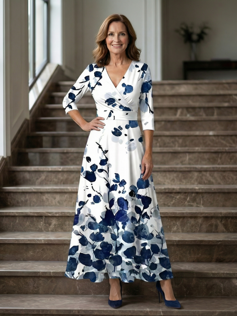 FJØRNA women's floral summer maxi dress with V-neck wrap design displayed on a model, lightweight and flowy fabric.