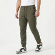 Men's slim fit cotton cargo trousers by FJØRNA, shown in a neutral color with multiple pockets and a modern tapered design.