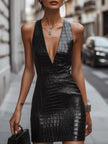 FJØRNA black croc-embossed leather mini dress displayed on a hanger, showcasing its textured pattern and sleek style.