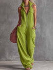 Bright green FJØRNA cotton linen women's zip-front jumpsuit with long sleeves and a relaxed fit, displayed on a hanger.