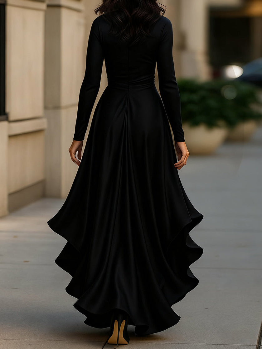 Navy blue FJØRNA satin maxi dress with draped fabric and ruffle details, flowing design perfect for elegant occasions.