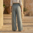 FJØRNA high waist wide leg white trousers for women, stylish and comfortable pants with a relaxed fit and flowy design.