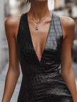 Black croc-embossed leather mini dress by FJØRNA, showcasing a fitted silhouette with a stylish textured finish.