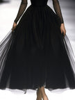 Black FJØRNA maxi dress for women featuring a flowing silhouette and sleeveless design, perfect for elegant occasions.