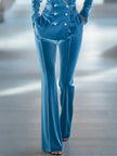 Blue loose velvet flared women's trousers from FJØRNA, showing the relaxed fit and soft fabric details.