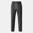 Men's relaxed fit wide-leg drawstring joggers from FJØRNA, casual sweatpants with adjustable waistband and comfortable fabric.