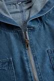 FJØRNA women's casual loose retro denim jumpsuit with hood, long sleeves, zipper front, and pocket details.