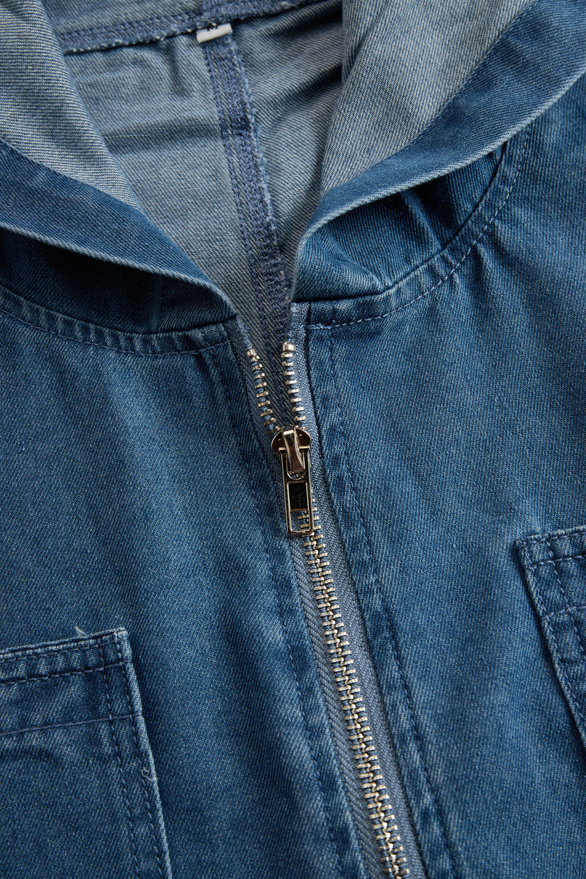 FJØRNA women's casual loose retro denim jumpsuit with hood, long sleeves, zipper front, and pocket details.