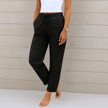 FJØRNA lightweight summer women's trousers with elastic waist, breathable fabric, and relaxed fit for comfortable warm-weather wear.