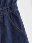 Dark blue denim FJØRNA women's sleeveless balloon jumpsuit with multi-pocket design and relaxed fit.
